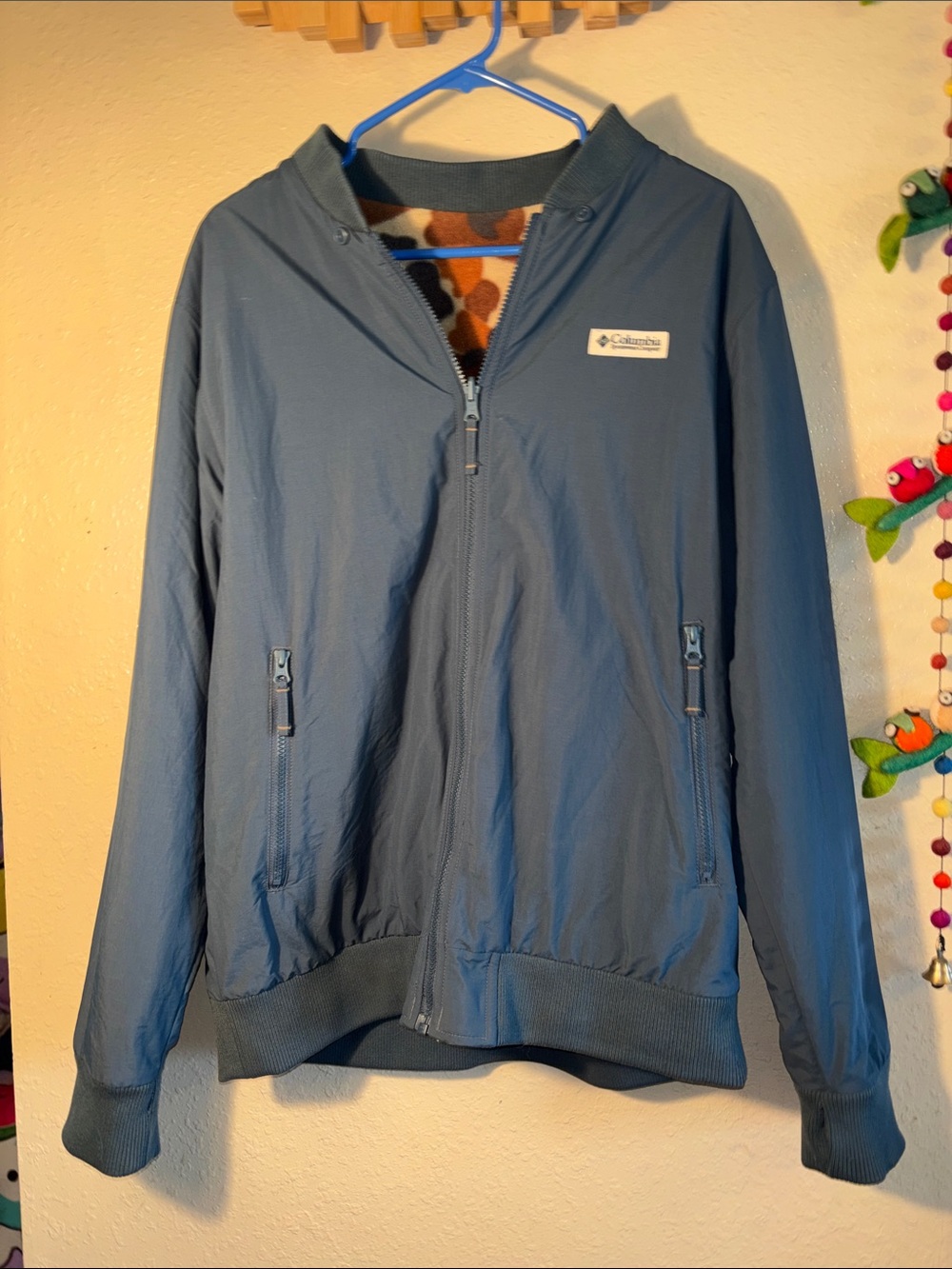 EUC Columbia Sportswear Reversatility Bomber Jacket. It features a blue nylon ou